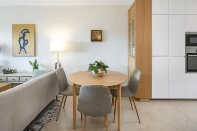 a kitchen and dining room with a table and chairs at Fairview Golfside Apartment at Boavista in Atalaia