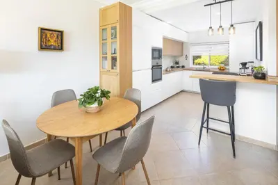a kitchen and dining room with a wooden table and chairs at Fairview Golfside Apartment at Boavista in Atalaia