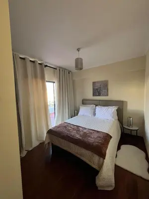 a bedroom with a large bed and a window at Ocean View II in Funchal