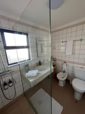 a bathroom with a toilet and a sink and a shower at Ocean View II in Funchal