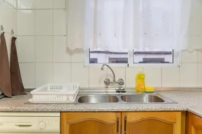 a kitchen counter with a sink and a window at Esmael Apartment By Mth in Funchal