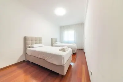 a bedroom with two beds and a mirror at Esmael Apartment By Mth in Funchal
