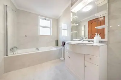 a white bathroom with a tub and a sink at Esmael Apartment By Mth in Funchal