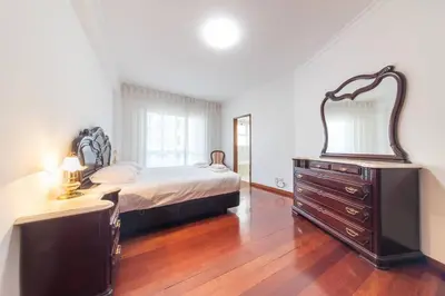 a bedroom with a bed and a dresser and a mirror at Esmael Apartment By Mth in Funchal