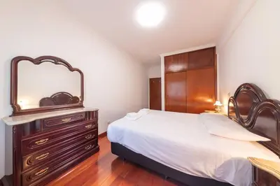 a bedroom with a bed and a dresser with a mirror at Esmael Apartment By Mth in Funchal