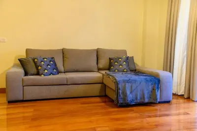 a couch in a living room with a wooden floor at Gorete Apartment 3 by Mth in Funchal