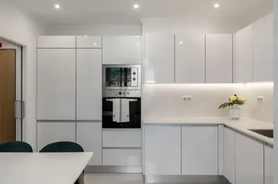 a kitchen with white cabinets and a stove at Casa Branca Penthouse by An Island Apart in Funchal