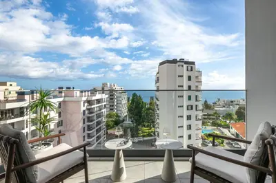 a balcony with chairs and a view of the ocean at Casa Branca Penthouse by An Island Apart in Funchal
