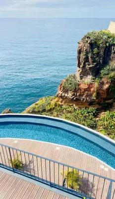 a swimming pool with a view of the ocean at Sea Front in Câmara de Lobos