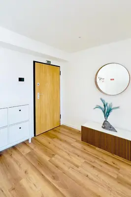 an empty room with a wooden door and a mirror at Sea Front in Câmara de Lobos