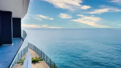 a view of the ocean from the balcony of a building at Sea Front in Câmara de Lobos