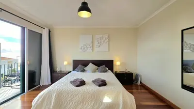 a bedroom with a bed with two towels on it at Atlantic Breeze in Câmara de Lobos