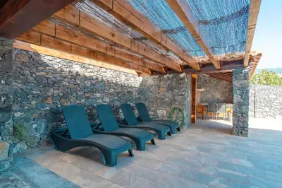 a dining room with a table and chairs and a couch at Camara De Lobos Lux Villa in Câmara de Lobos