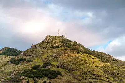 a mountain with a cross on top of it at GuestReady - Machico Apartment with Balcony in Machico