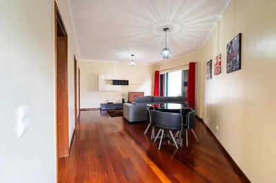 a living room with a table and a couch at GuestReady - Machico Apartment with Balcony in Machico