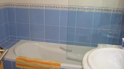 a bathroom with a sink and a shower and a tub at St James Apartment in Luz