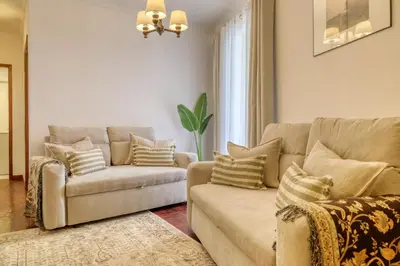 a living room with a couch and a chair at Cantinho da Elvira, a Home in Madeira in Funchal