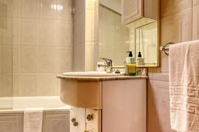 a bathroom with a sink and a bath tub at Cantinho da Elvira, a Home in Madeira in Funchal