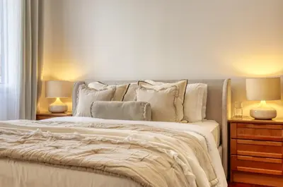 a bedroom with a white bed with two lamps at Cantinho da Elvira, a Home in Madeira in Funchal