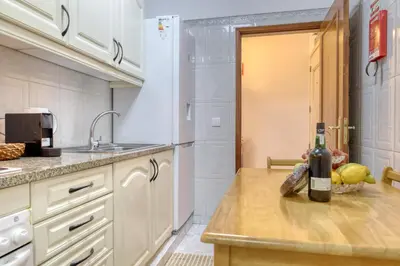 a kitchen with a bottle of wine on a counter at Cantinho da Elvira, a Home in Madeira in Funchal