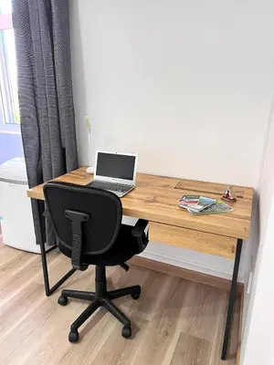 a wooden desk with a laptop computer on it at Bravas House 1 in Tábua