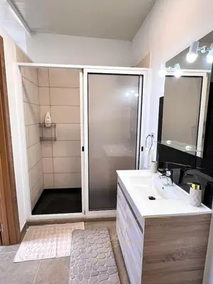 a bathroom with a shower and a sink at Bravas House 1 in Tábua
