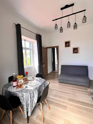 a living room with a table and a bed at Bravas House 1 in Tábua