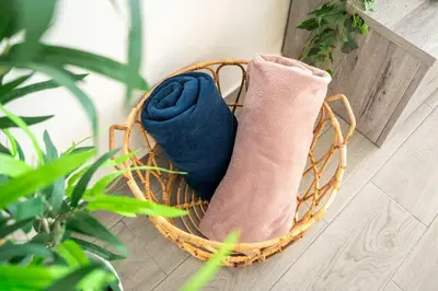 a wicker basket with two pillows on a porch at Beachfront Flat & Panoramic Sea View by HostWise in Luz