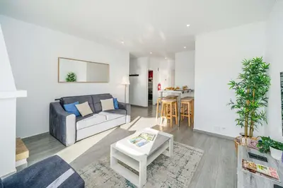a living room with a couch and a table at Beachfront Flat & Panoramic Sea View by HostWise in Luz