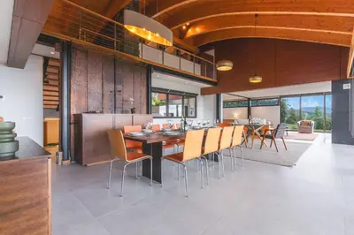 a dining room with a table and chairs at Casa Vista Azul by Atlantic Holiday in Santo da Serra