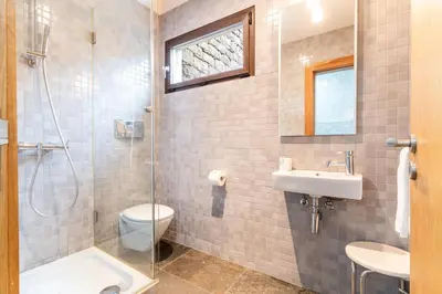 a bathroom with a toilet and a sink and a shower at Casa Vista Azul by Atlantic Holiday in Santo da Serra