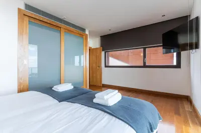 a bedroom with a large bed and a large window at Casa Vista Azul by Atlantic Holiday in Santo da Serra