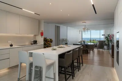 a kitchen and dining room with a table and chairs at Savoy Monumentalis X by An Island Apart in Funchal