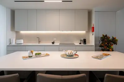 a kitchen with a table with two plates of food on it at Savoy Monumentalis X by An Island Apart in Funchal