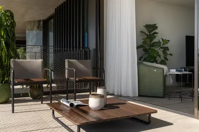 a room with two chairs and a wooden table at Savoy Monumentalis X by An Island Apart in Funchal