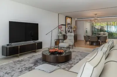 a living room with a tv and a couch and a table at Savoy Monumentalis X by An Island Apart in Funchal
