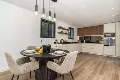 a kitchen and dining room with a table and chairs at Villa Favila by Madeira Dream Stays in Funchal