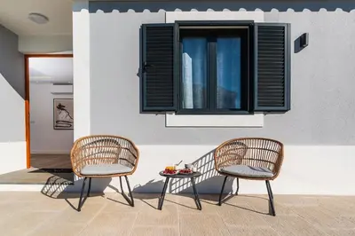 two chairs and a table in front of a window at Villa Favila by Madeira Dream Stays in Funchal