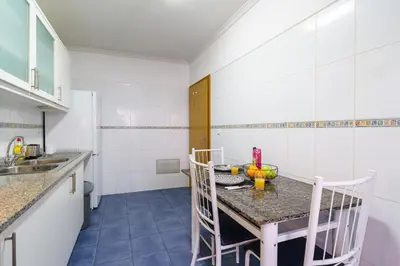 a kitchen with a table and chairs in a room at Atlantic View Nº3 in Caniço