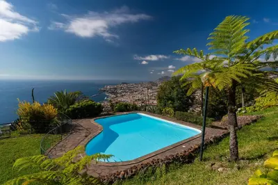 a swimming pool with a view of the ocean at Atlantic Ocean by Holiday Rental Madeira in Funchal