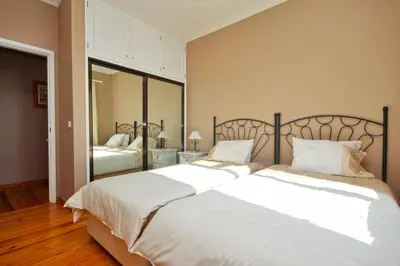 a bedroom with two beds with white sheets at Atlantic Ocean by Holiday Rental Madeira in Funchal