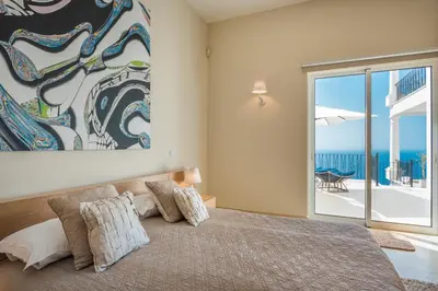 a bedroom with a bed with a view of the ocean at Villa La Terrasse by Holiday Rental Madeira in Funchal