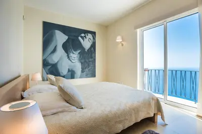 a bedroom with a bed and a large window at Villa La Terrasse by Holiday Rental Madeira in Funchal