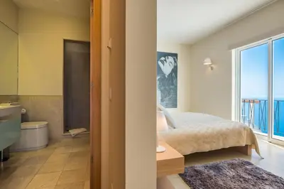 a bedroom with a bed and a view of the ocean at Villa La Terrasse by Holiday Rental Madeira in Funchal