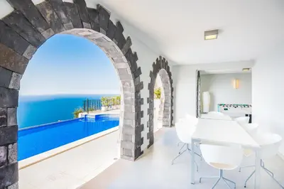 a dining room with a view of the ocean at Villa La Terrasse by Holiday Rental Madeira in Funchal
