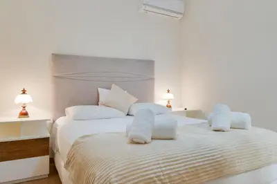 a bedroom with a bed with towels on it at Oasis do Norte by Holiday Rental Madeira in São Jorge