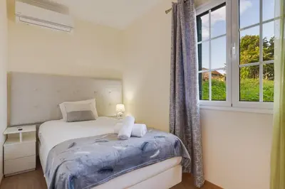 a bedroom with a bed and a window at Oasis do Norte by Holiday Rental Madeira in São Jorge