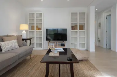 a living room with a couch and a tv at Baía II by An Island Apart in Funchal