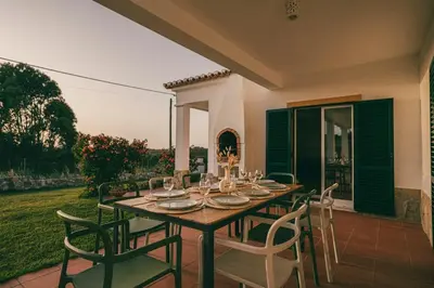 a dining table and chairs on a patio at Villa Hideaway - Splendid Sea View with a Pool in Aljezur