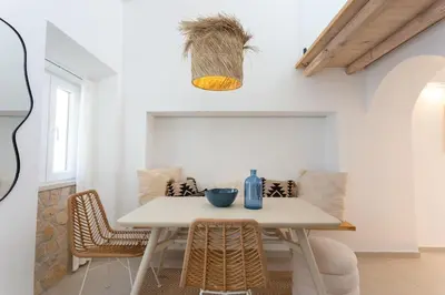 a dining room with a white table and chairs at tiny BEACH HOUSES - 2 min to Beach in Salema
